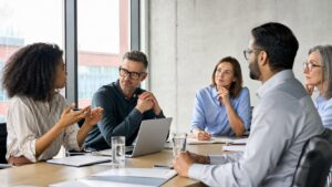 Modern manager leading a thoughtful team discussion in a bright meeting room